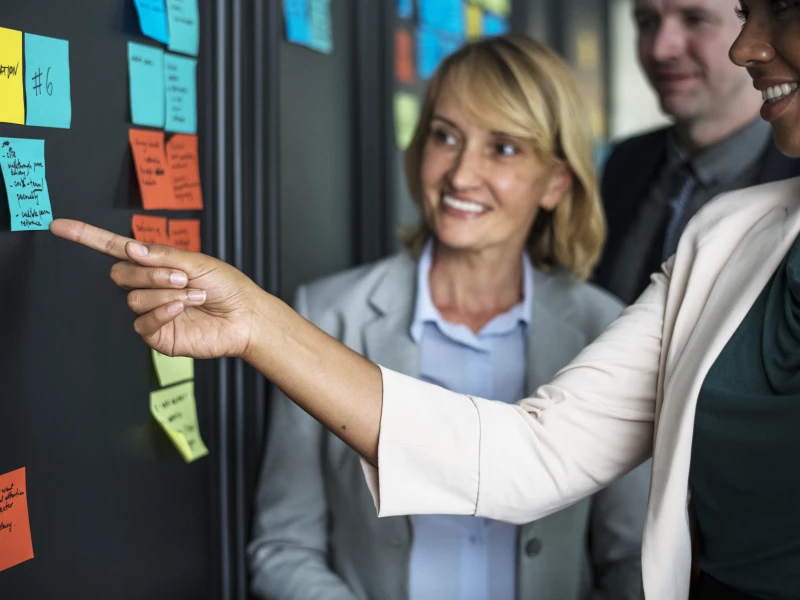 Business people planning tasks with sticky notes